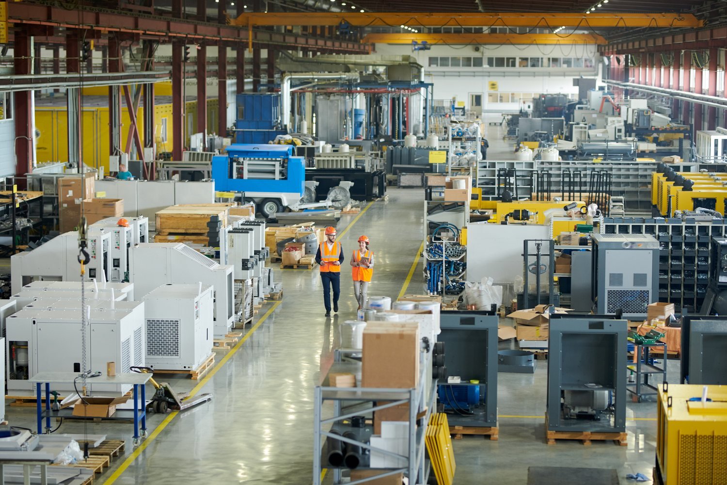 Inspection in a plant workshop with industrial machinery and operators